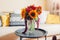 Fresh sunflowers and zinnia flowers put in vase in living room. Interior and home decor. Bouquet of fall blooms on table