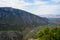 Fresh surrounding view of Parnassus mountain slope valley, green olive groves through Ionian sea with bright sky background