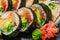 Fresh sushi with cucumber maki, carrot, sea cabbage and salmon maki