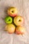 Fresh sweet apples on reusable textile grocery bag on dark grey background