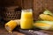 Fresh sweet corn juice (corn milk) and corn on wood background