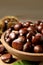 Fresh sweet edible chestnuts in wooden bowl on table, closeup