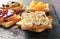 Fresh sweet toasts with fruits on slate plate, closeup