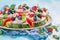 Fresh and sweet watermelon pizza with cream and fresh fruits