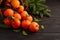 Fresh tangerine clementine with spices on dark wooden background