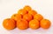Fresh tangerines in a billiards triangle at the table