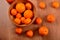 Fresh tangerines and oranges in a clay bowl