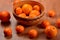 Fresh tangerines and oranges in a clay bowl