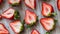 Fresh, tasty looking halved ripe strawberries on rustic wooden table