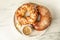 Fresh tasty pastries and coffee on white marble table