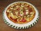 Fresh tasty pizza on decorated plate