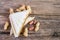 Fresh tasty sandwich and peanut on wooden table