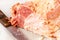 Fresh tasty smoked bacon piece cross section, piece of meat cut in half with a knife, closeup. Simple pork ham meat cutting