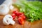 Fresh and tasty tomatoes, salad, champignon on cutting board