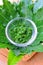 Fresh Thai herb mashed neem leaf on glass bowl.