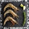 Fresh tiger shrimp on ice on a black stone table