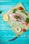 Fresh tilapia on blue wooden textured background with fresh rosemary and lemon. Culinary mediterranean seafood