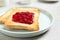 Fresh toasts with jam for breakfast on light grey table, closeup