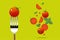 Fresh tomato on fork with flying tomatoes background , healthy food concept