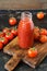 Fresh tomato juice in a glass bottle, cherry tomatoes.