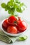 Fresh tomatoes and basil on kitchen table