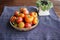 Fresh tomatoes in basket on table