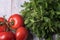 Fresh tomatoes and frizzy parsley on a wooden table