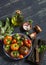 Fresh tomatoes, garden herbs and olive oil