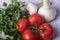 Fresh tomatoes, garlic and frizzy parsley on a wooden table