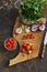 Fresh tomatoes, onion, garlic, parsley and chile on wooden board