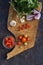 Fresh tomatoes, onion, garlic, parsley and chile on wooden board