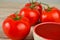 Fresh tomatoes and tomatoe paste on a wooden table