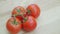 Fresh tomatoes on the vine on wooden table