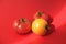fresh tomatoes of yellow and red color close-up on a red background in a beam of bright light. Healthy food concept
