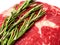 Fresh top quality ribeye steak with rosemary leafs on white isolated background,