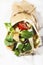 Fresh tortilla wrap with vegetables and roasted chicken.