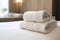 Fresh Towels Arranged On Hotel Room Bed