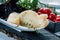 Fresh, traditional Italian cow or goat and sheep cheese semi-sweet Caciocavallo, Scamorza with aromatic herbs in the cut. On a