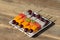 Fresh tropical fruit on skewers in white plate - healthy breakfast, weight loss concept. Thailand