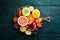 Fresh tropical fruits on a black background. Citrus, melon, pomegranate, strawberry, banana. Top view.