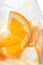 Fresh tropical or summer lemonade with orange and ice in glass, detail photography, abstract