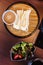 Fresh Udon with sesame sauce served in bamboo mat with salad