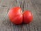 Fresh ugly red farm tomato on wooden background. Trendy vegetarian vegetables. Healthy food