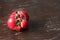 Fresh ugly trendy tomato on brown background. Organic food