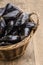 Fresh and uncleaned mussels in a wicker basket