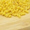 Fresh uncooked gold colored pasta, on bamboo cutting board