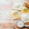 Fresh uncooked ravioli and rolling pin