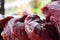 Fresh uncooked red meat on the wooden table ready to be cooked on the outdoor fire grill. Barbecue  in the garden