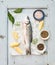 Fresh uncooked seabass fish with lemon, herbs, ice and spices on rustic blue wooden board backdrop