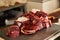 Fresh uncooked sliced meat on scales in meat market